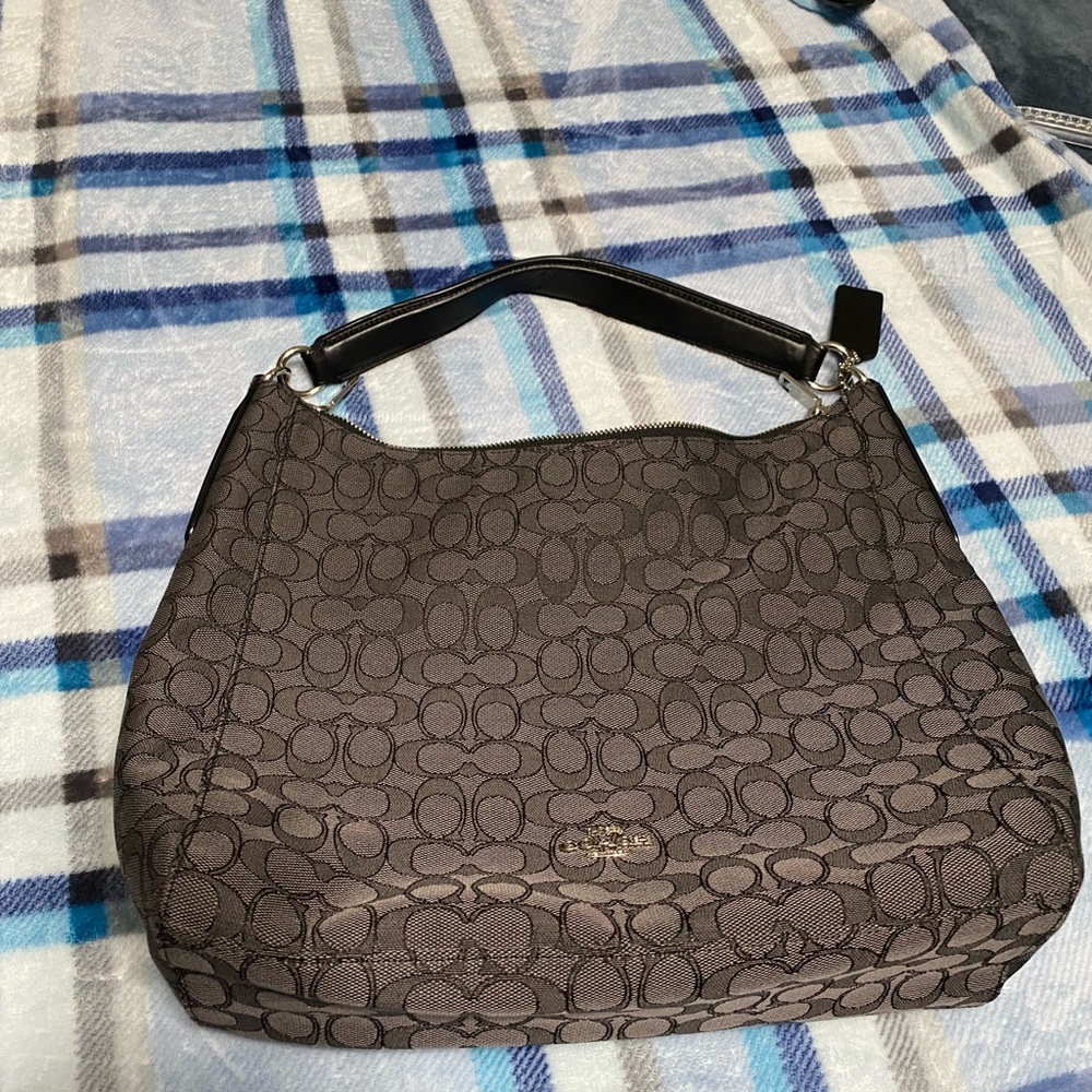 This is a black block C patterned Coach purse.